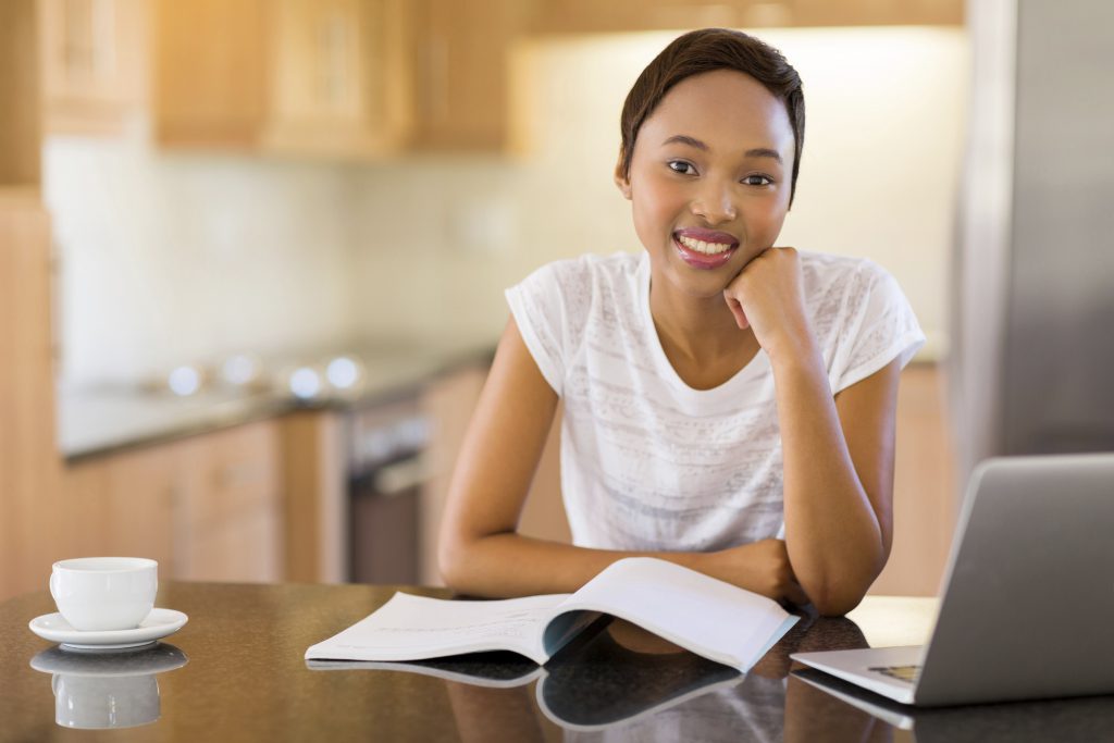 portrait of pretty female african college student studying at home